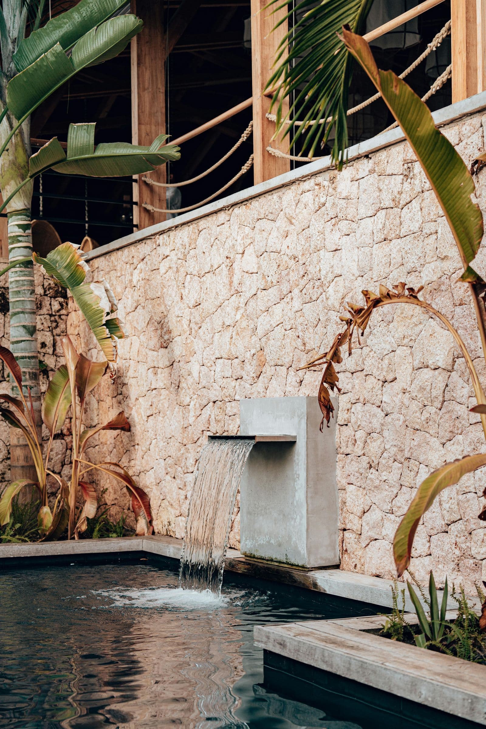 Tropical stone wall with water feature at a Dominican property