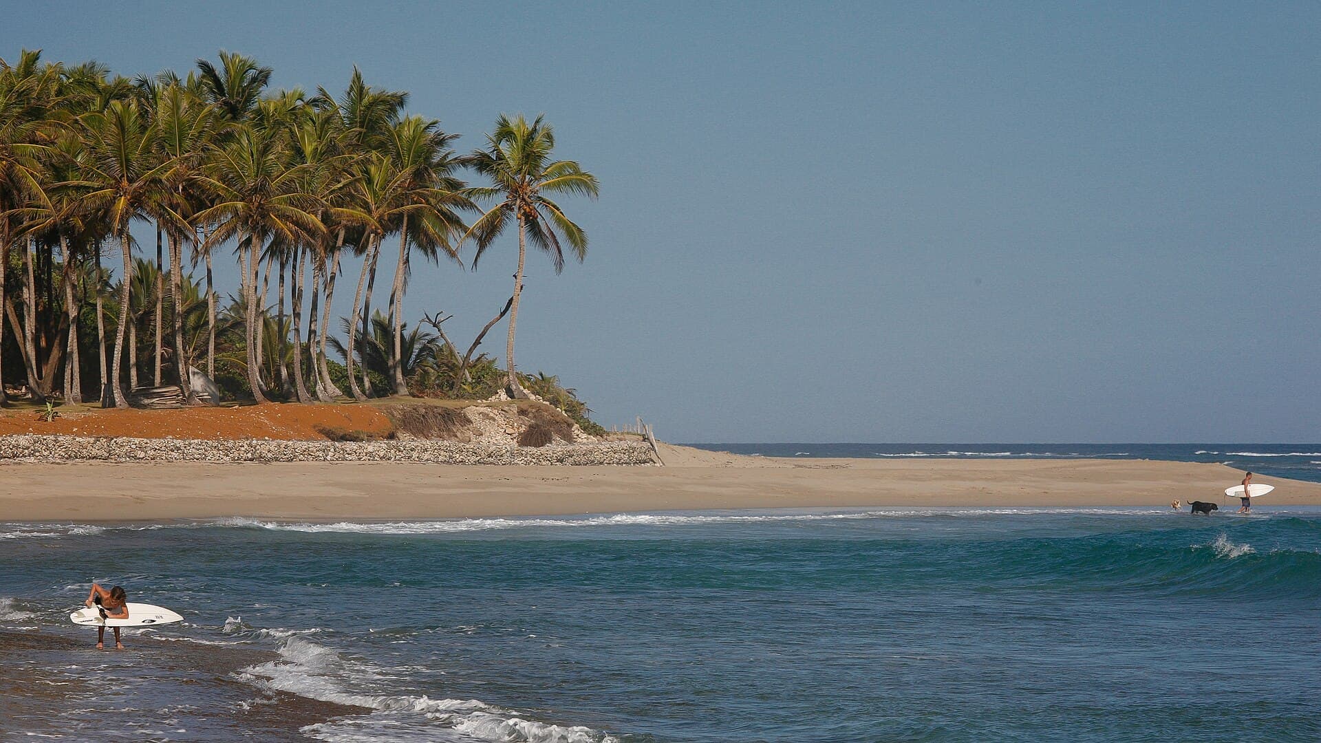 Surfers on the beach at Cabarete, Dominican Republic
