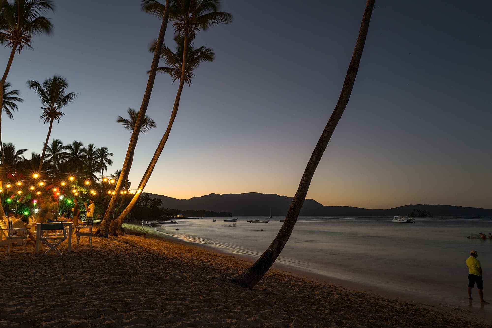 Palms and fishing boats on the beach at Las Galeras, Samaná, at dusk
